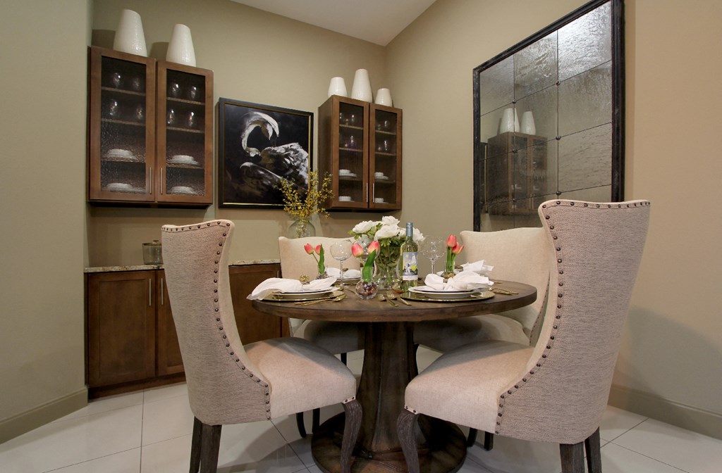 Luxury dining room with built-in buffet with granite slab top, and 10-foot ceilings at Tuscany Walk Apartments in Houston Texas.