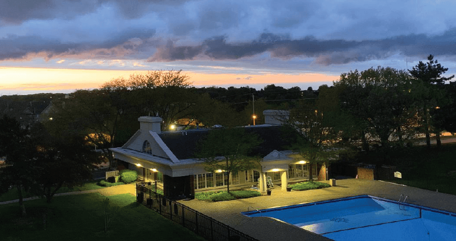 Resort-style saltwater pool with huge sun deck, poolside lounge chairs, and park-like setting with lots of trees and scenic views at Embassy Park Apartments in Omaha, Nebraska
