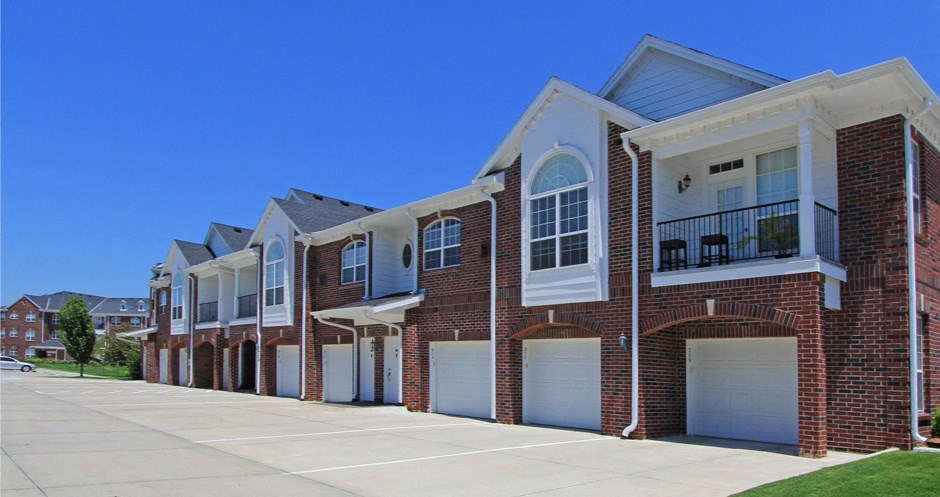 Luxury townhomes with attached garages and red brick exterior next to Rockledge Shopping Center in South Lincoln Nebraska