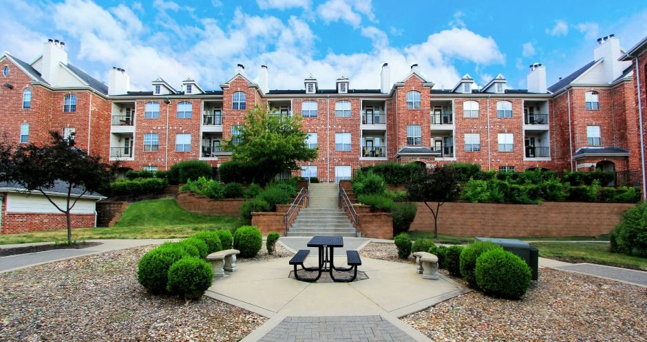 Luxury apartments with red brick exteriors, lush landscaping, landscaped courtyard, and beautiful grounds at TurtleCreek Apartments in West Des Moines