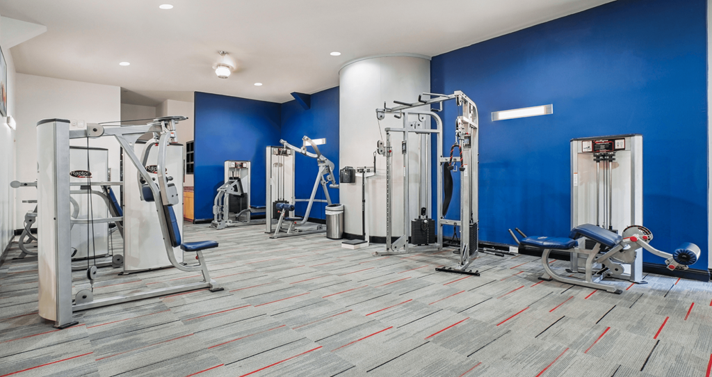 A gym with a variety of exercise equipment.