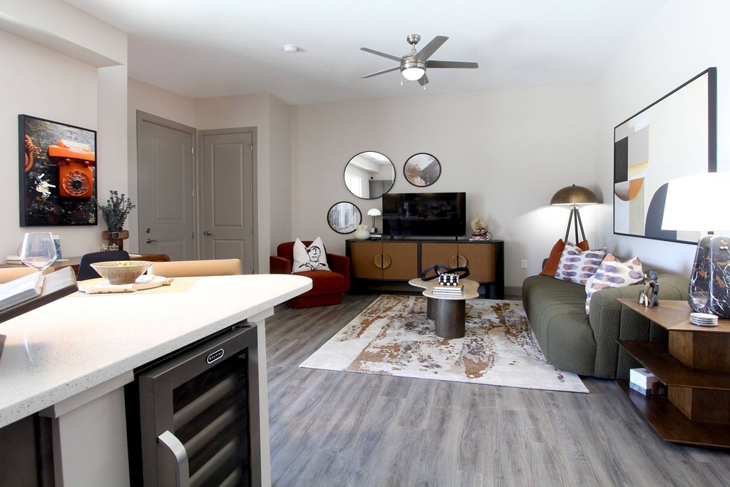 A modern kitchen with a dining area and a living room.