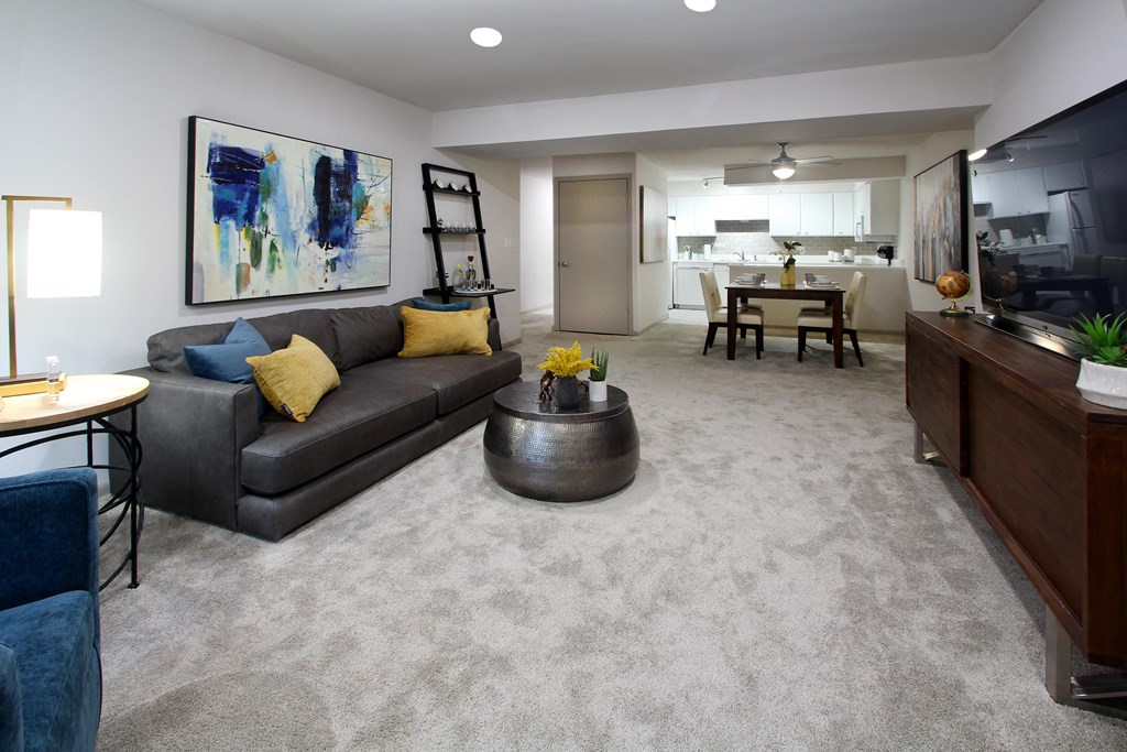 A living room with a grey couch and a coffee table.