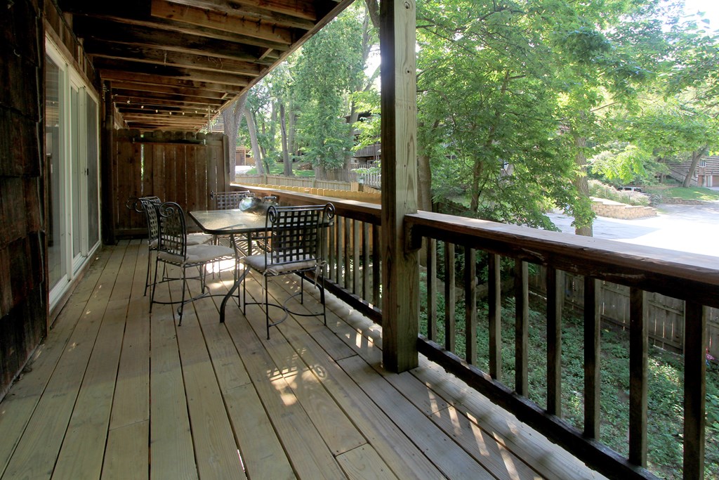 A wooden deck with a table and chairs.