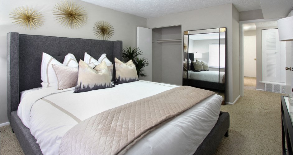 Spacious bedroom with walk-in closet and gray wall color at Inwood Apartments in La Vista, Nebraska
