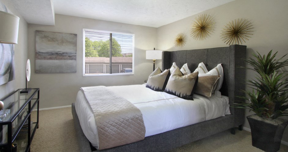 Spacious bedroom with walk-in closet and gray wall color at Inwood Apartments in La Vista, Nebraska