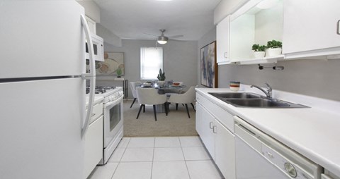 a white kitchen with a sink and a refrigerator
