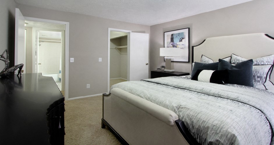 Spacious bedroom with walk-in closet and gray wall color at Inwood Apartments in La Vista, Nebraska