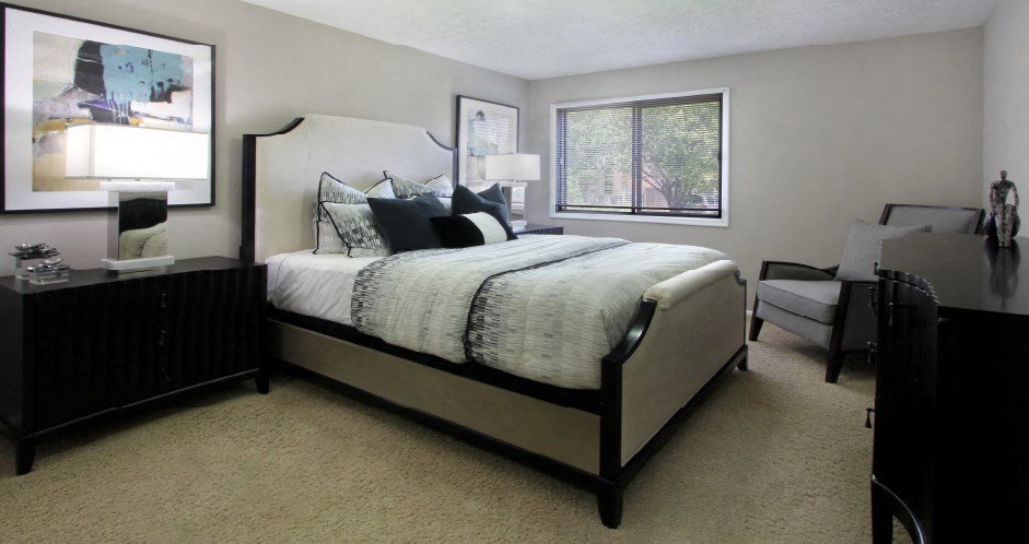 Spacious bedroom with walk-in closet and gray wall color at Inwood Apartments in La Vista, Nebraska