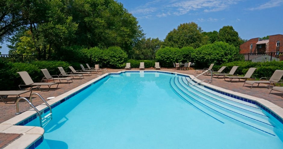 Large private swimming pool with lush landscaping at Inwood Village Apartments in La Vista, Nebraska