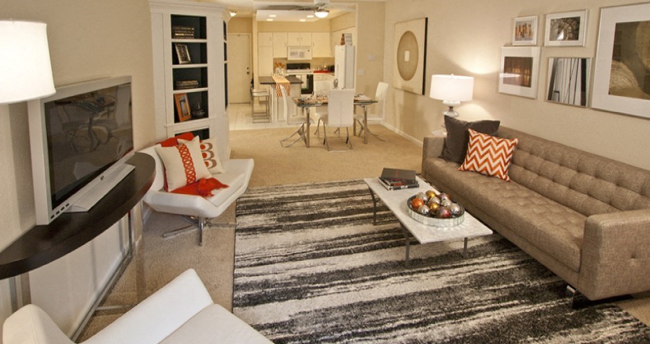 Spacious apartment in central Omaha with condo-style layout, white kitchen cabinets, kitchen island, and built-in shelves at Embassy Park Apartments