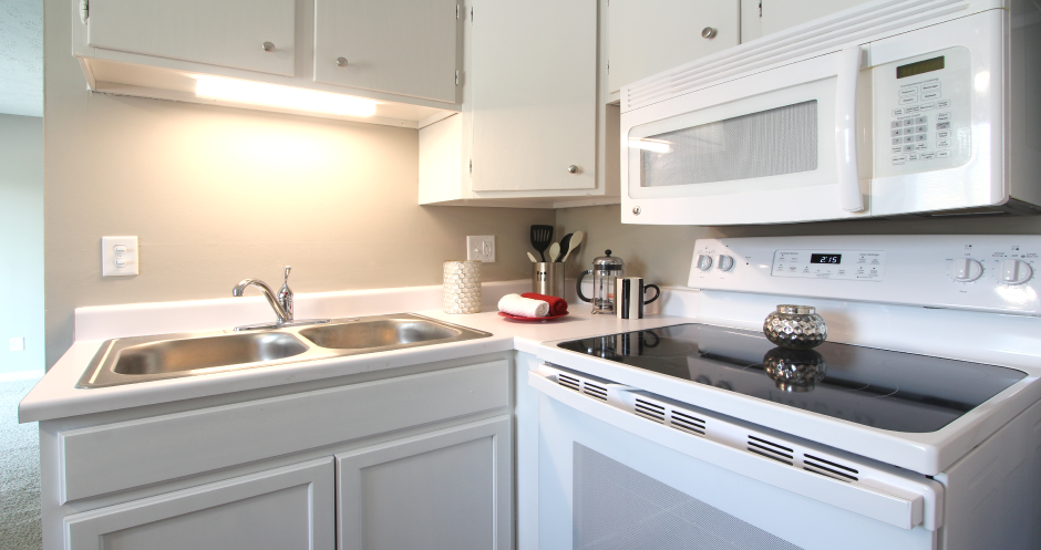Kitchen with white cabinets, bright white kitchen at Kensington Woods Apartments in Omaha, Nebraska