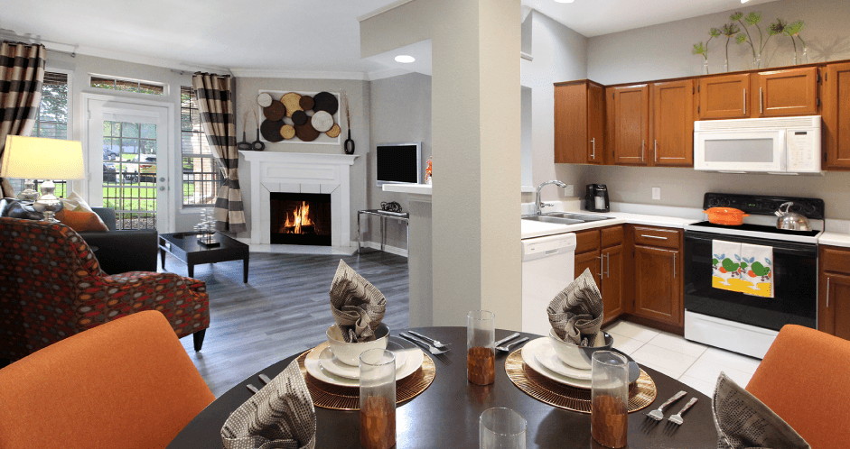 Luxury apartments with wood grain plank floors, dining room, u-shaped kitchen, 9-foot ceilings, and woodburning fireplace at Lenox Village Apartments in Lincoln, Nebraska