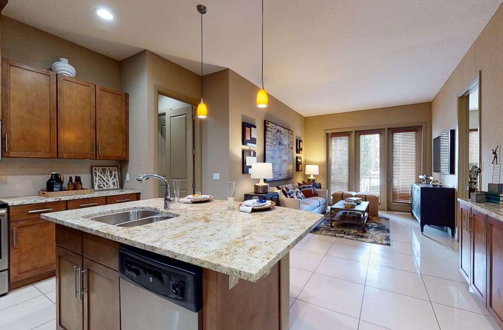 Luxury apartments in Bloomington Minnesota with spacious floor plan, granite countertops, stainless steel appliances, built-in wine rack, kitchen island, and porcelain tile floor at Luxembourg Apartments