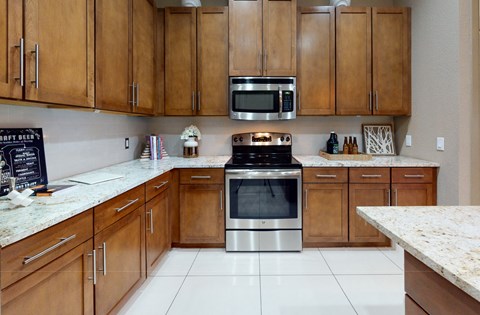 a kitchen with wooden cabinets and stainless steel appliances