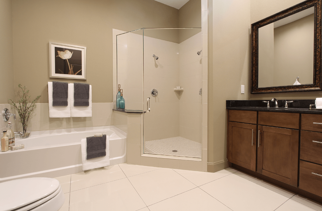 Luxury bathroom with granite countertops, glass shower and separate soaking tub at Luxembourg Apartments in Bloomington Minnesota