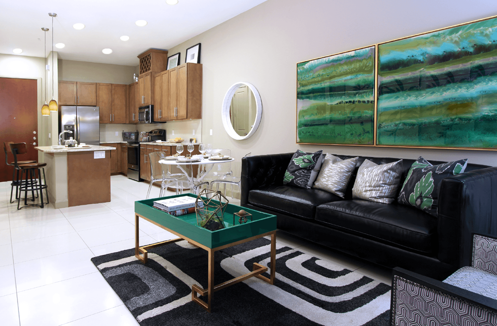 Luxury apartments in Bloomington Minnesota with granite countertops, stainless steel appliances, built-in wine rack, kitchen island, and porcelain tile floor at Luxembourg Apartments