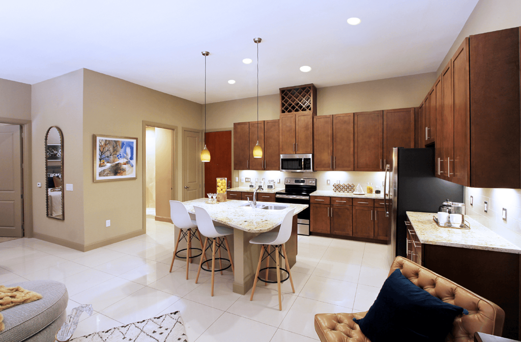 Luxury apartments in Bloomington Minnesota with spacious floor plan, granite countertops, stainless steel appliances, built-in wine rack, kitchen island, and porcelain tile floor at Luxembourg Apartments