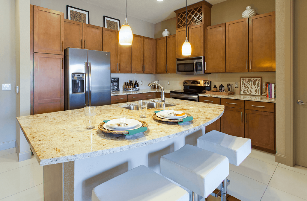 Luxury apartments in Bloomington Minnesota with spacious floor plan, granite countertops, stainless steel appliances, built-in wine rack, kitchen island, and porcelain tile floor at Luxembourg Apartments