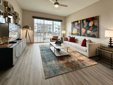 A living room with a couch, a coffee table, and a painting on the wall.