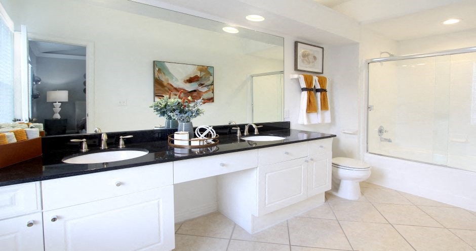 Spacious master bathroom with granite countertops, double sink vanity, double mirror vanity, at Tuscany Villas Apartments in Houston, Texas