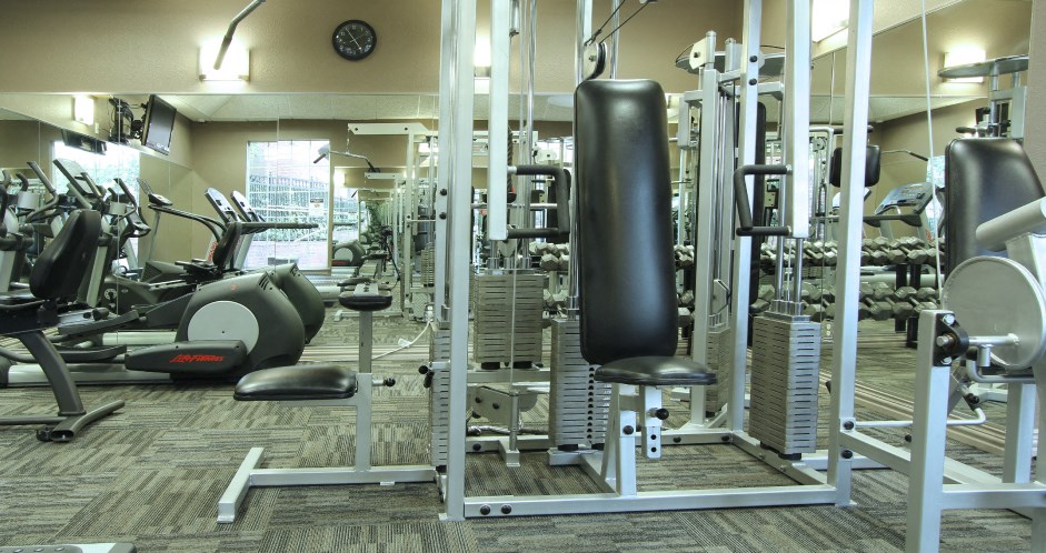 Luxury apartments with a fitness center in a gated community with red brick exteriors at Prestonbridge Apartments in North Dallas