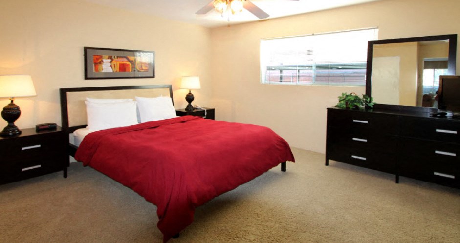 Spacious bedroom with ceiling fan and walk-in closet at Plantation apartments near the Galleria in Houston.