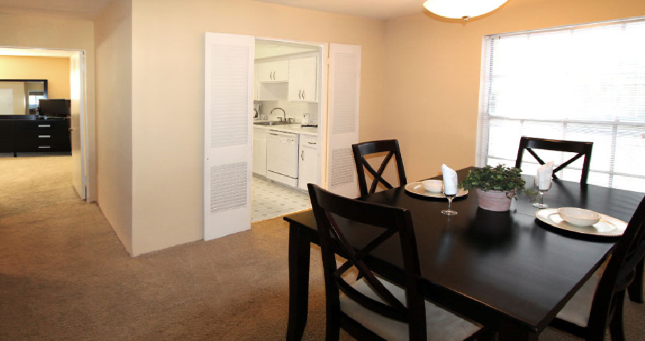 Spacious dining room and bright white kitchens at Plantation apartments in Houston.