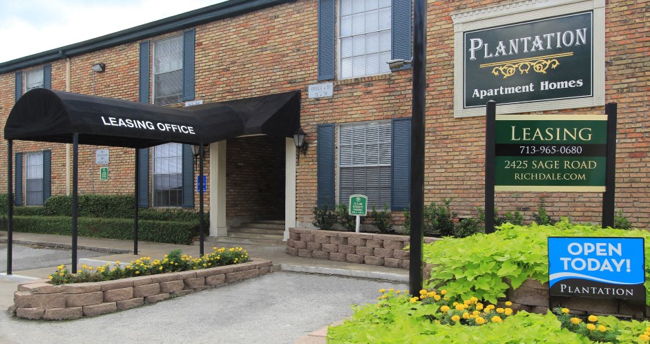 a brick building with a leasing office and an open today sign