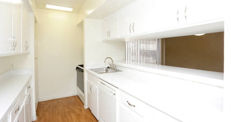 Apartments near the Galleria with bright white kitchens, wood plank floors, and extra cabinet space
