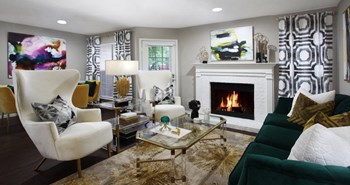 Spacious apartments with wood plank floors, woodburning fireplace, French door, and oversized windows at Preston Village Apartments - Photo Gallery 2