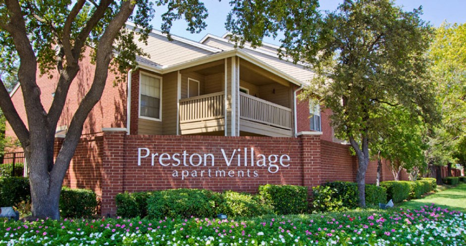 Luxury apartments in north Dallas with beautiful landscaping, scenic views, and red brick exteriors at Preston Village Apartments
