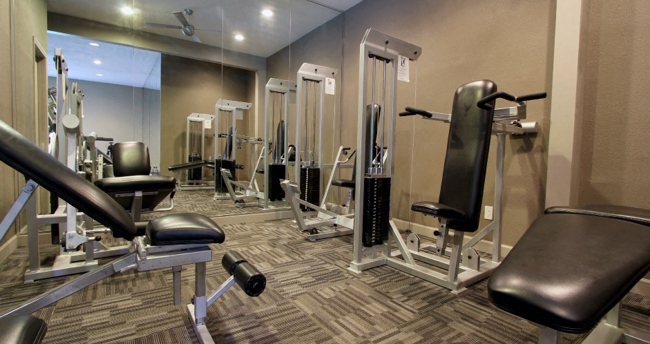 Luxury apartments with a fitness center in a gated community at Preston Village Apartments in North Dallas