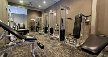 Luxury apartments with a fitness center in a gated community at Preston Village Apartments in North Dallas - Photo Gallery 7