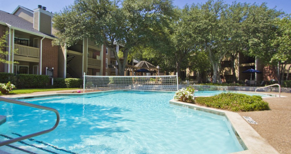 Luxury apartments with beautiful fountains, beautiful landscaping, gazebo, spa, and swimming pool with poolside lounge chairs, grilling station and scenic views at Preston Village Apartments in north Dallas