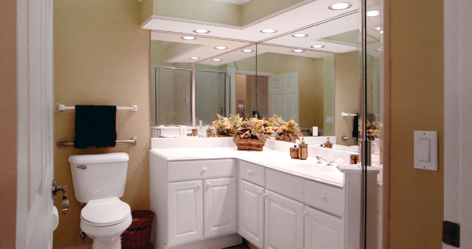 Luxury apartments with oval soaking tub, separate glass shower, built-in vanity, and cultured marble vanity top at RidgeGate Apartments in Minnetonka, Minnesota