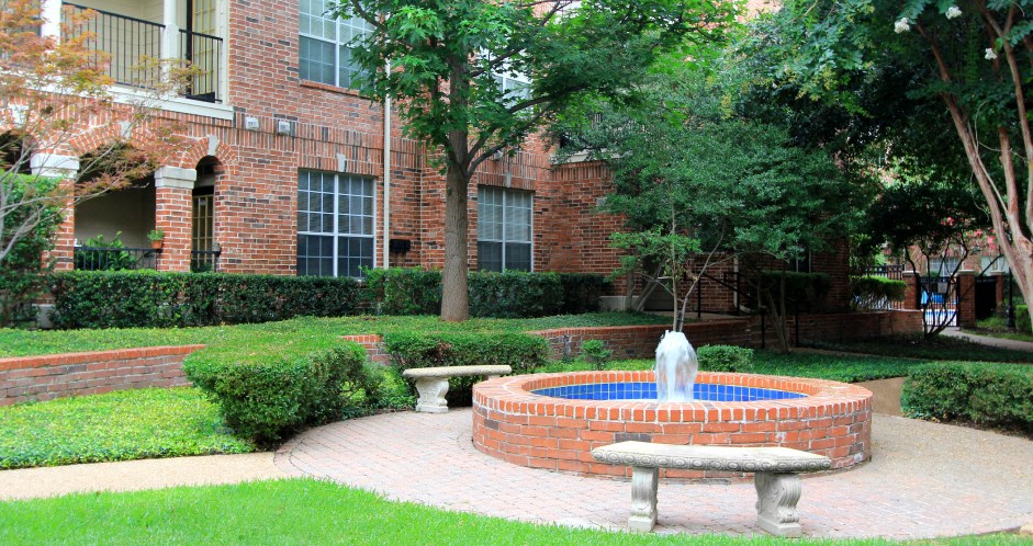 Gated apartment community with landscaped courtyards, beautiful landscaping, and beautiful courtyards with fountains at The Saxony Apartments in north Dallas