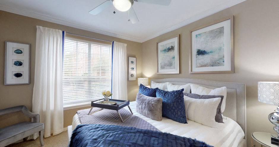 Luxury apartments with spacious bedrooms, walk-in closets, and ceiling fans at Tuscany Gate Apartments in Houston.