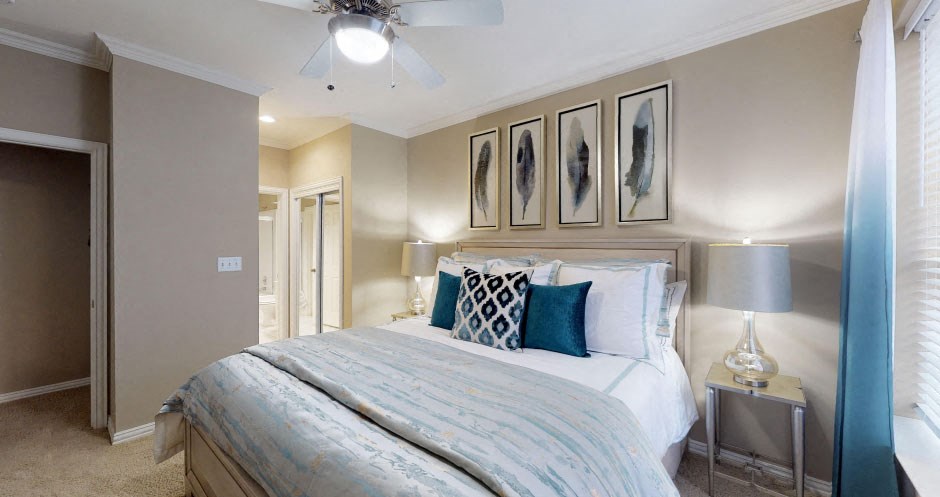 Luxury apartments with spacious bedrooms, walk-in closets, and ceiling fans at Tuscany Gate Apartments in Houston.