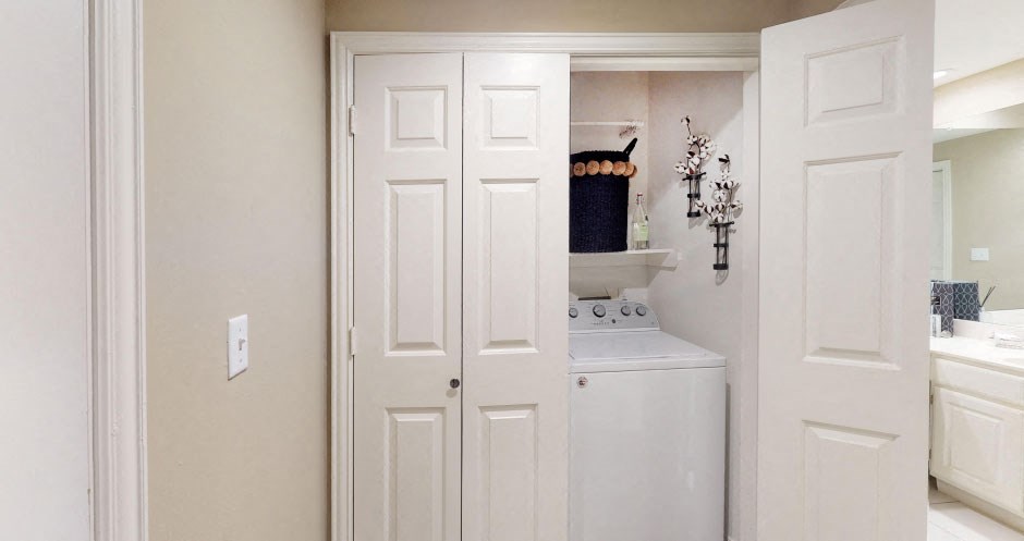 a small kitchen with white cabinets and a white refrigerator