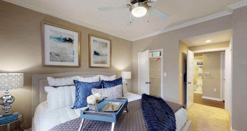Luxury apartments with spacious bedrooms, walk-in closets, and ceiling fans at Tuscany Gate Apartments in Houston.