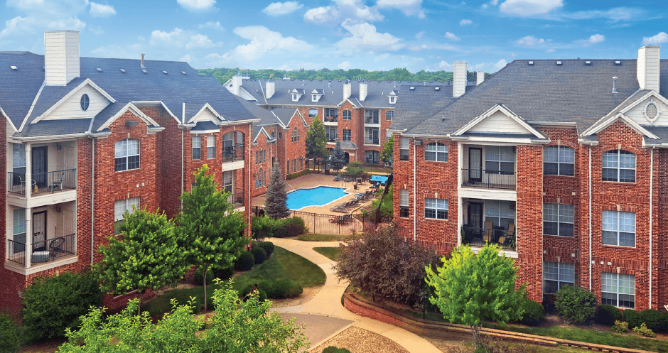 Luxury apartments with red brick exteriors, spacious balcony, and lush landscaping at TurtleCreek apartments in West Des Moines, Iowa
