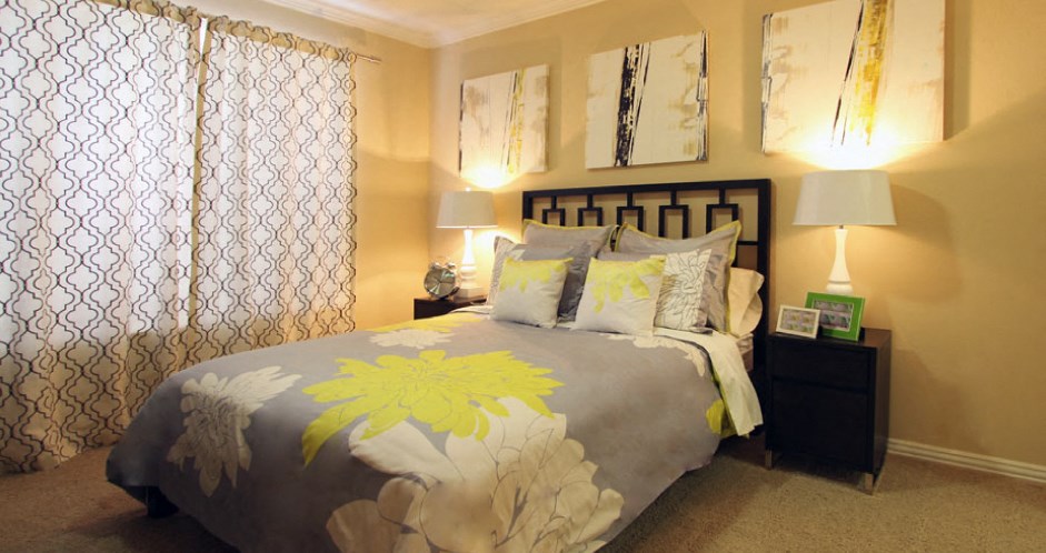 Spacious bedroom with walk-in closet and ceiling fan at Tuscany Oaks Apartments in Houston.