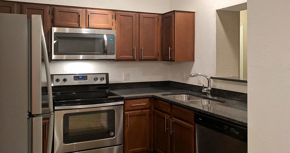 Luxury apartments with granite countertops, stainless appliances, and custom cabinetry at Tuscany Oaks Apartments in Houston.