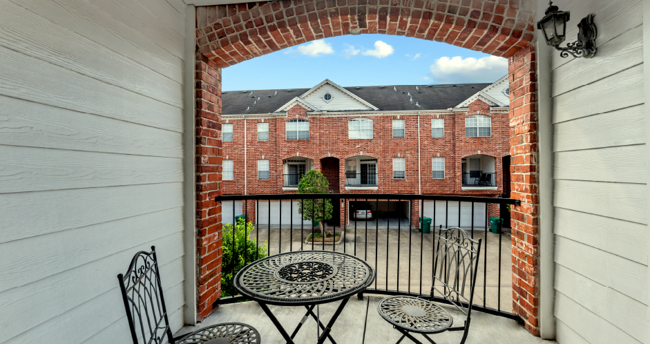 Luxury townhomes in a gated community with red brick exteriors and attached 2-car garages at Tuscany Row Townhomes in Houston.