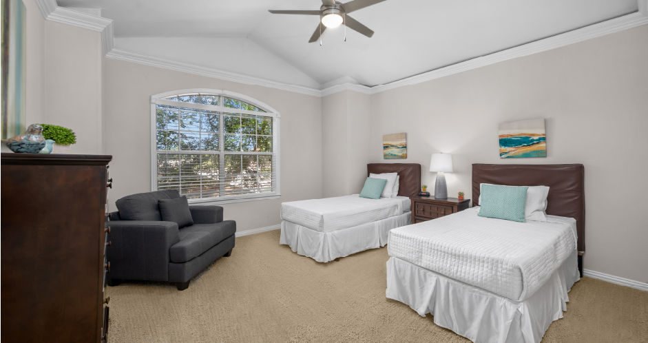 Huge bedroom, spacious bedroom with vaulted ceiling, ceiling fan, walk-in closet, and attached bathroom at Tuscany Row Townhomes in Houston.