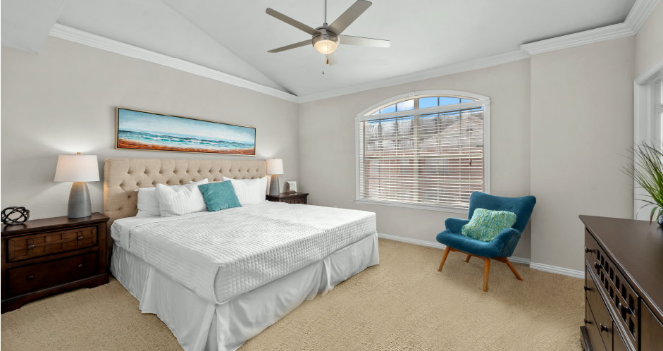 Huge master bedroom, spacious master bedroom with ceiling fan, high vaulted ceiling, over-sized windows, walk-in closet and attached luxury bath suite at Tuscany Row Townhomes in Houston.