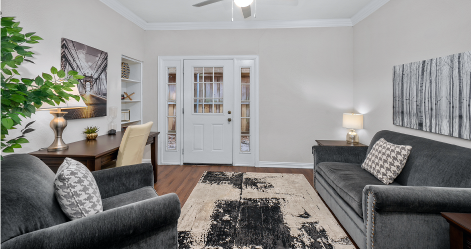 Huge office space, spacious den with built-in shelves, hardwood floors, and private backyard patios at Tuscany Row Townhomes in Houston.