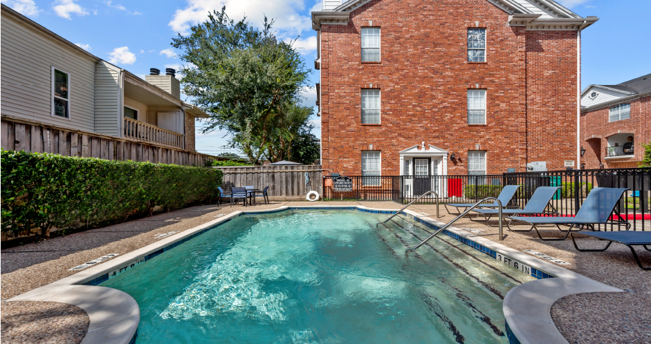 Luxury townhomes with swimming pool and poolside lounge seating at Tuscany Row in Houston.