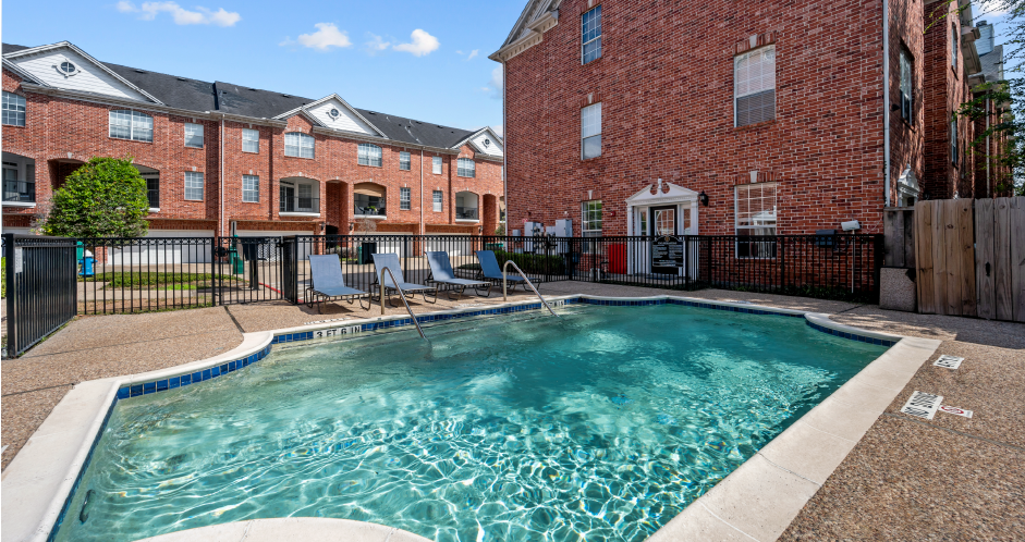 Luxury townhomes with swimming pool and poolside lounge seating at Tuscany Row in Houston.